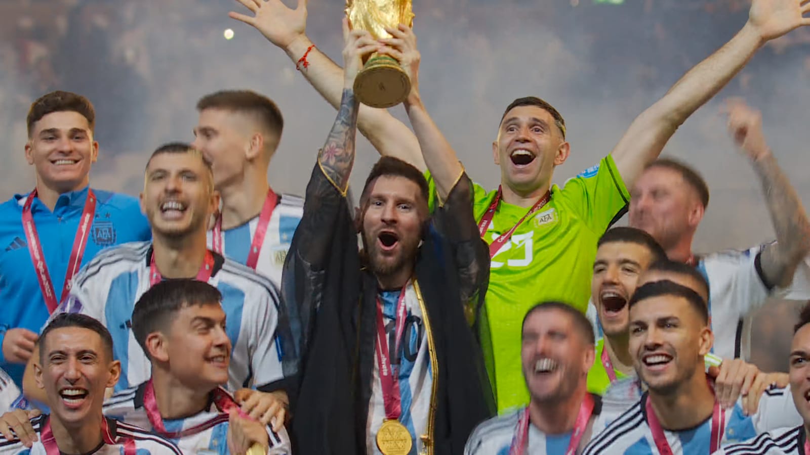 Messi levanta la copa del Mundial rodeado por el plantel durante la premiación.